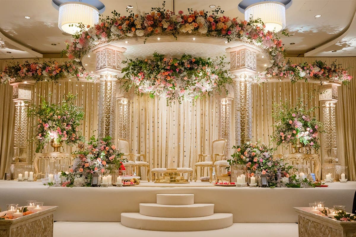 Round carved canopy with peach and blush flowers and a hanging floral cloud