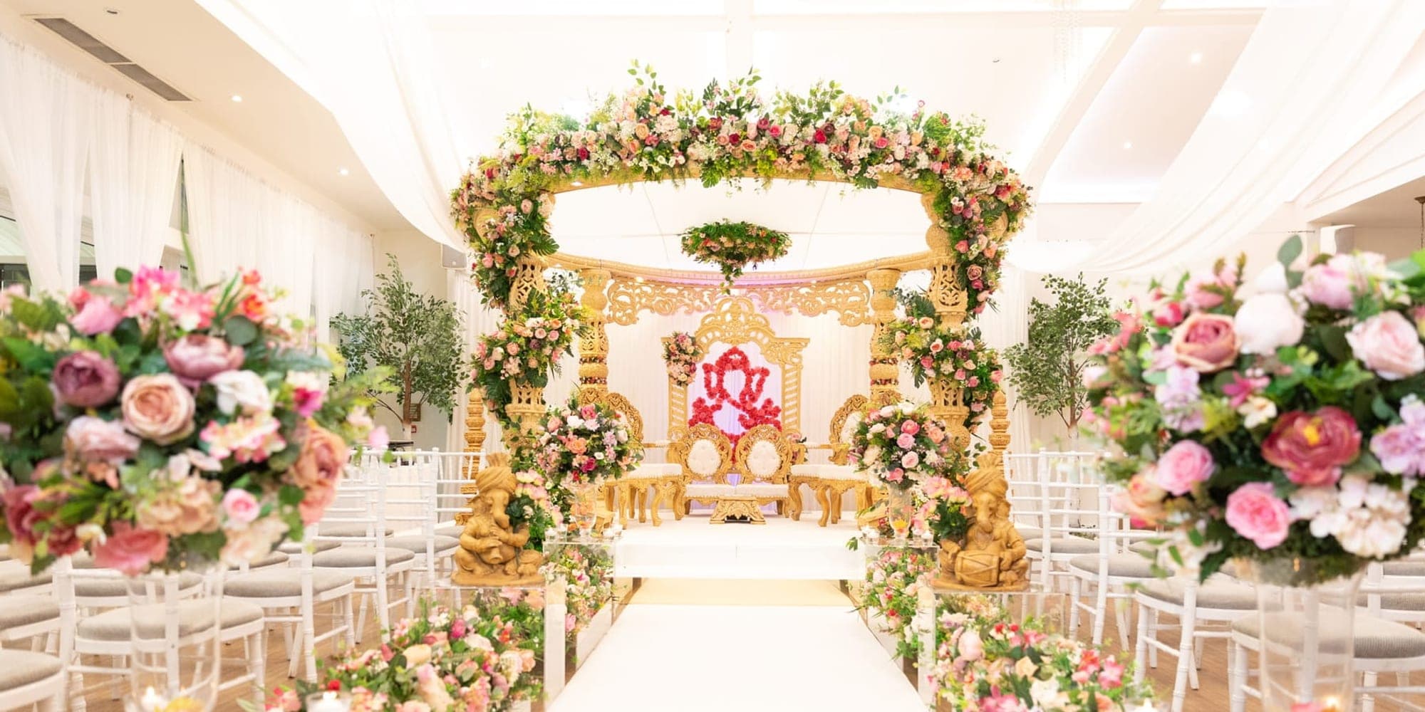 Aisle Decor, Entrance Gates and Carpets for Asian Weddings White aisle lined with acrylic blocks and flowers leading to a floral round mandap