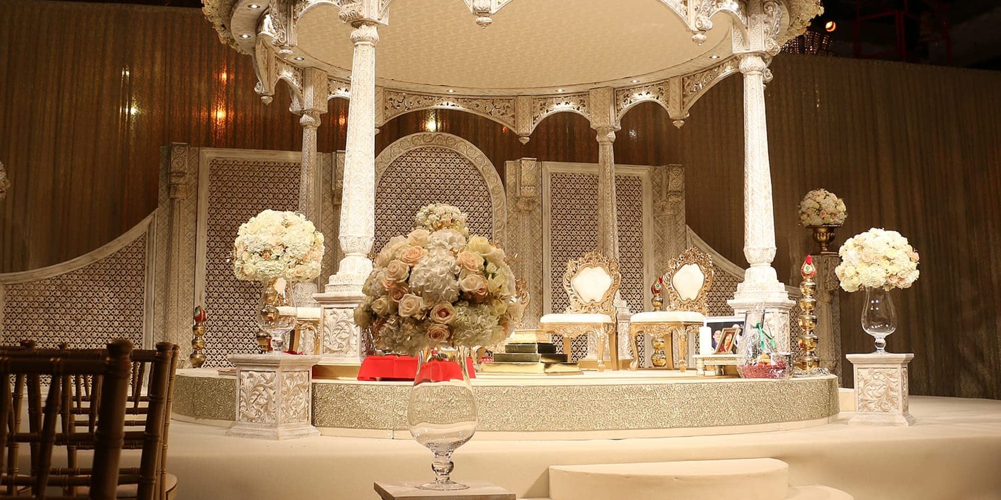 Mandap for a Large Wedding: Scale and Sightlines Grand white pillar and floral canopy mandap on a raised round stage