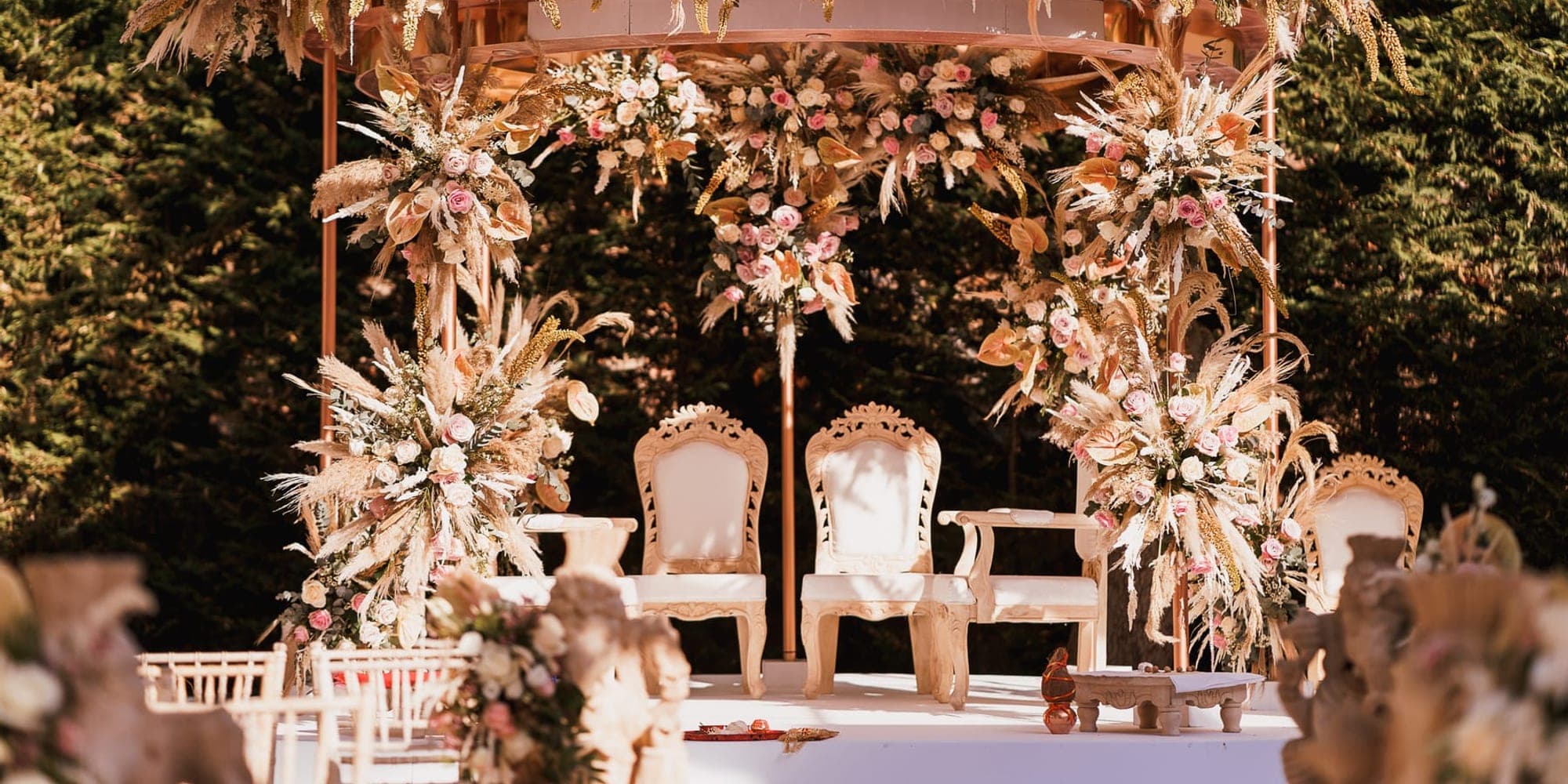 Mandap for a Small Wedding: Compact Designs and Tips Intimate pampas and rose floral mandap with cream chairs in a garden marquee