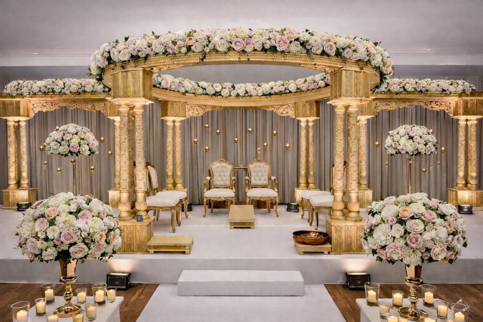 Gold pillared mandap with ivory and blush roses and rose urns Gold pillared mandap with ivory and blush roses and rose urns