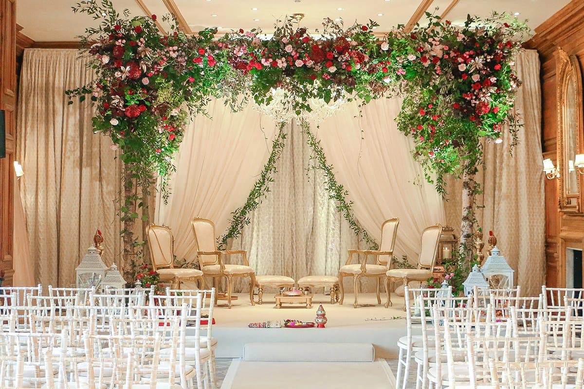 Birch posts with ivy and rose clusters over gilt chairs and ivory drapes Birch posts with ivy and rose clusters over gilt chairs and ivory drapes