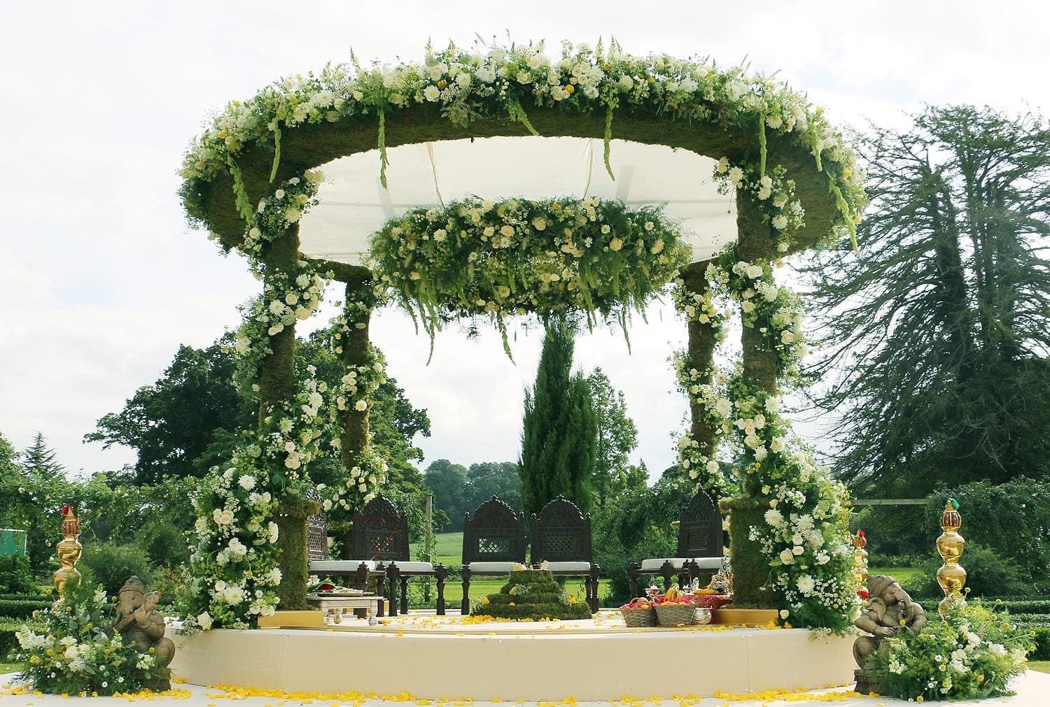 Moss-covered round canopy with white flowers and hanging ring in a garden Moss-covered round canopy with white flowers and hanging ring in a garden